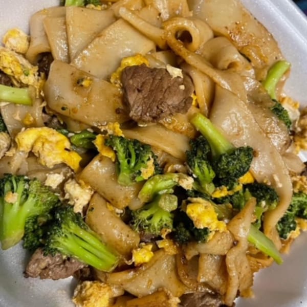 Close-up of Thai Orchid Alaska's Pad See Ew with wide noodles, beef, broccoli, and scrambled egg.